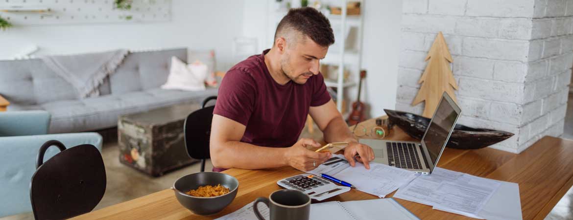 man at home doing finances
